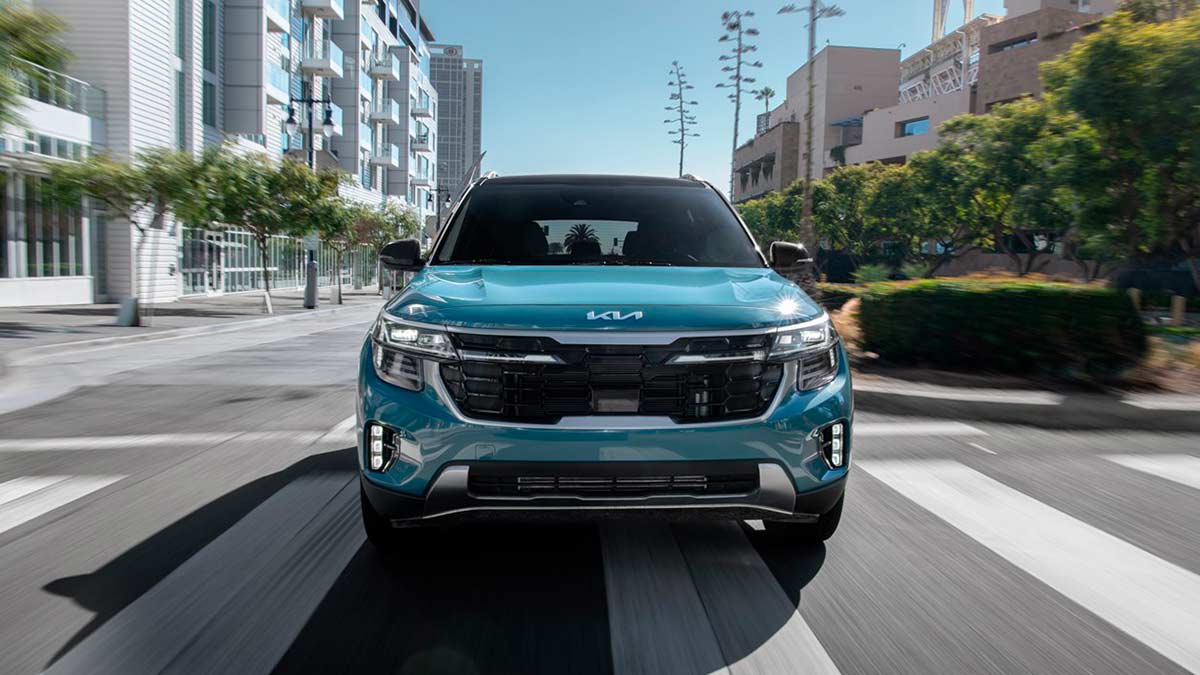 Kia Seltos driving on an urban street.