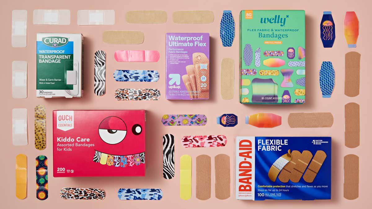 grid of Curad, Ouch Essentials, Up&Up, Band-Aid, and Welly bandage boxes and bandages