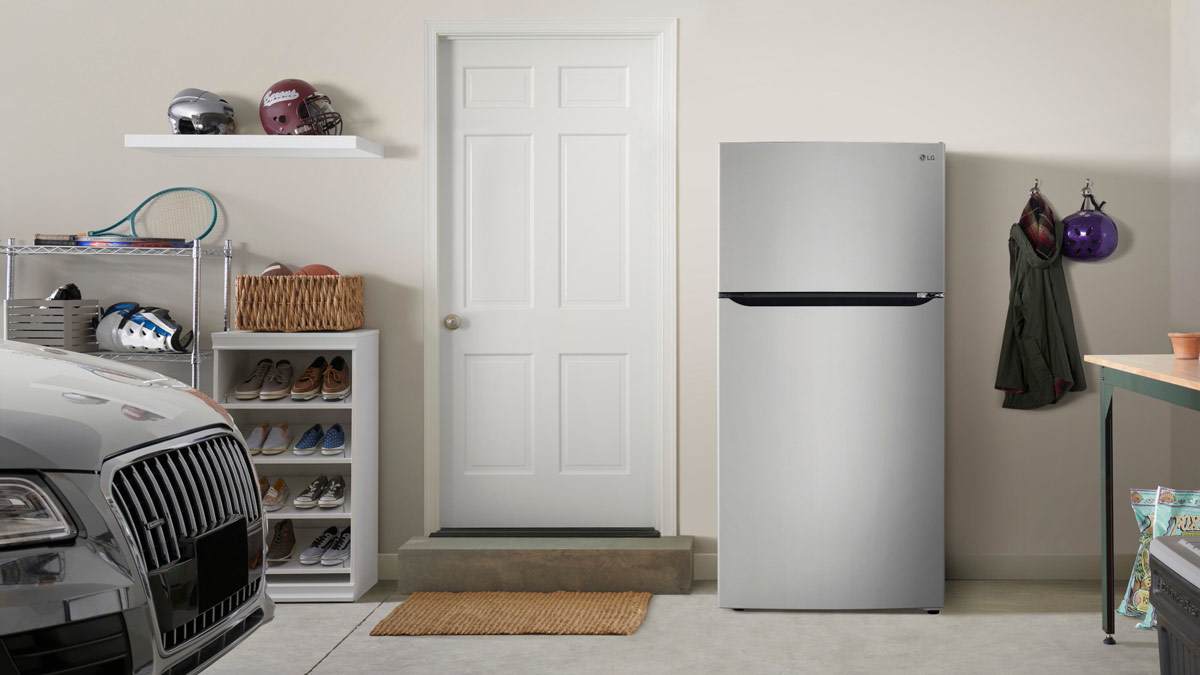 LG LRTLS2403S refrigerator in garage with door into house, corner of car, helmets, and shoe rack
