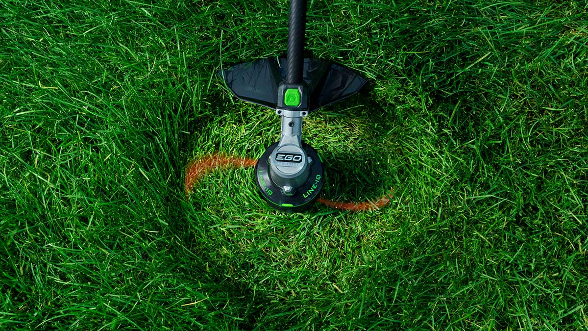 An Ego string trimmer seen from above cutting grass.