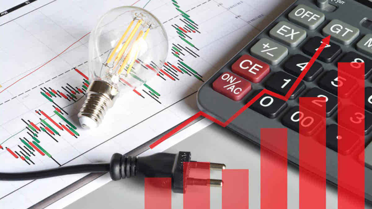 A lightbulb, power plug, and calculator on top of financial charts