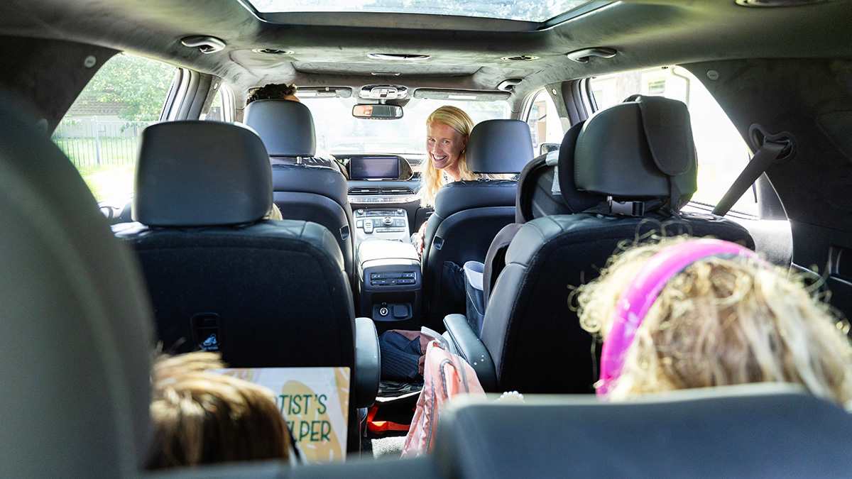 Family in large 3-row vehicle