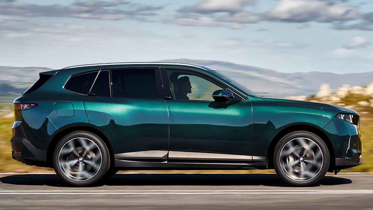 Side view of the 2027 BMW X5 40 being driven.