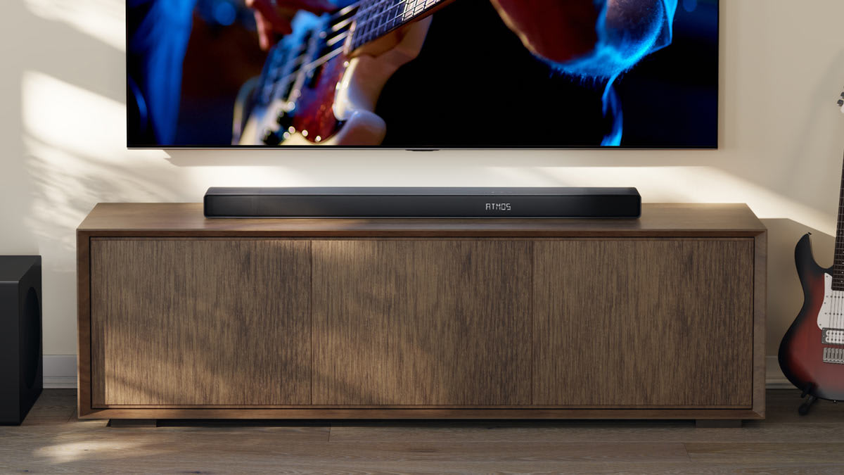 Hisense AX3120Q soundbar on a media unit with a TV and electric guitar.