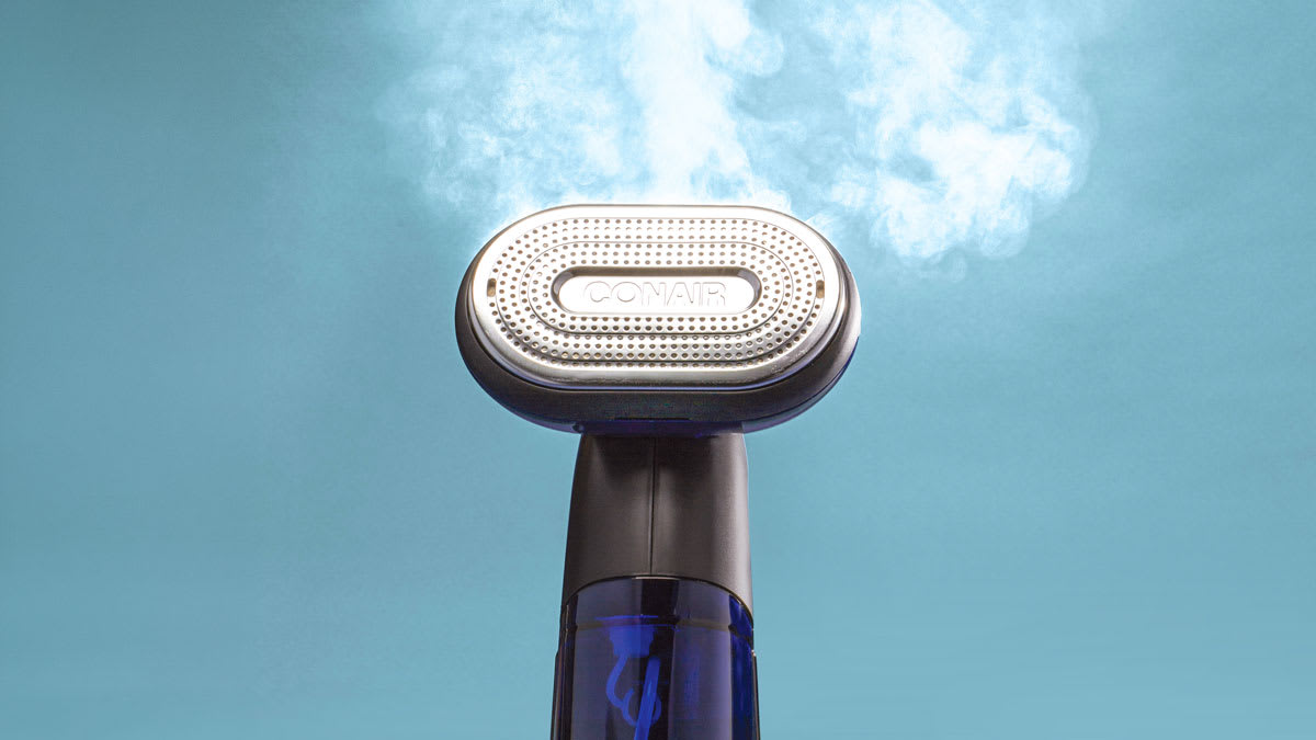 Conair ExtremeSteam 2-in-1 clothes steamer with cloud of steam coming out of it