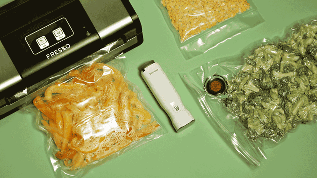 Video of Fresko vacuum sealer sucking air out of clear bag filled with food, next to Zwilling vacuum sealer and other bags of vacuum sealed food