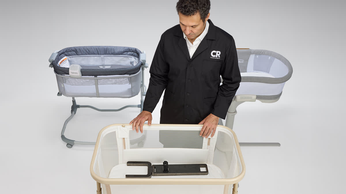 Consumer Reports Test Program Leader, Product Safety and Sustainability Juan Alberto Arguello Garcia Pertusa demonstrating a safety test by placing Hinge Gauge and Inclinometer in a cantilevered bassinet.