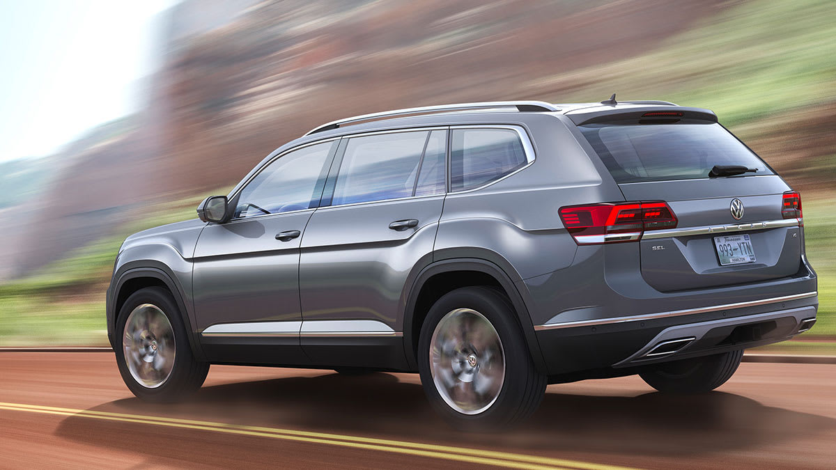 2018 Volkswagen Atlas driving, shown from left rear with much motion blur in background.