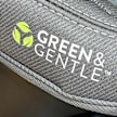 A closeup of car seat material where it says the words "Green & Gentle" with a symbol of three green leaves.