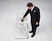 Consumer Reports Test Program Leader, Product Safety and Sustainability Juan Alberto Arguello Garcia Pertusa demonstrating a Head-to-Toe Sleep Surface Angle test by placing Hinge Gauge and Inclinometer in a cantilevered bassinet.