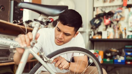 Someone working on bicycle using tools