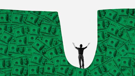 person in whole surrounded by $100 dollar bills