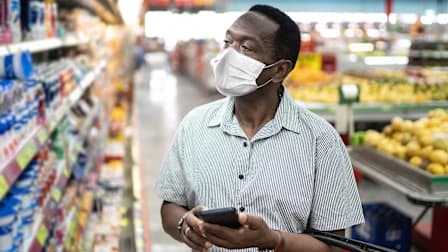 Person shopping in a grocery store wearing a face mask.