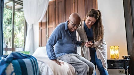 aid helping person get out of bed