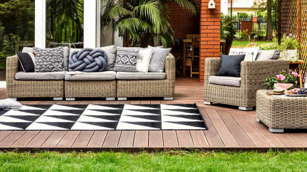 Outdoor sitting area on a deck with an outdoor rug