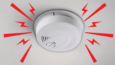 Image of a fire alarm with illustrated shapes to connote the alarm noise.