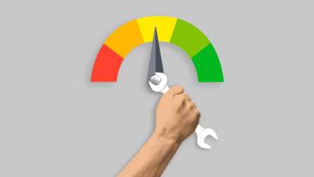 Hand with wrench adjusting credit score meter