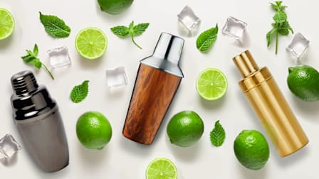 Boisson Gunmetal Cocktail Shaker, True Wooden Finish Cocktail Shaker and Hawkins NY Simple Cocktail Shaker surrounded by limes, mint and ice cubes