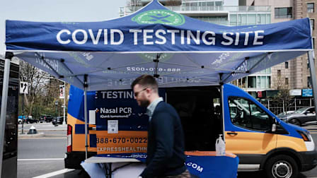 A pedestrian walks by an outdoor Covid-19 testing site in New York City.