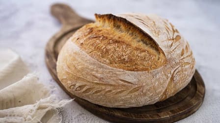 a loaf of sourdough bread on a cutting board