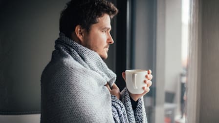 Man looking out window
