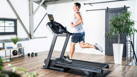 A person running on a Horizon Fitness 7.0 AT treadmill.