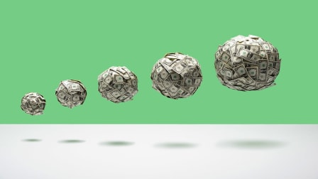 Growing balls of money floating in mid air