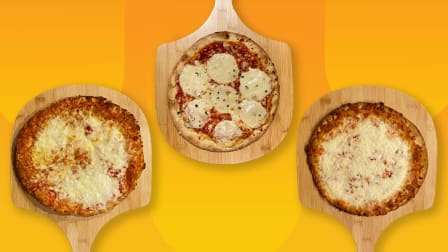 three cheese pizzas on wooden boards on orange background
