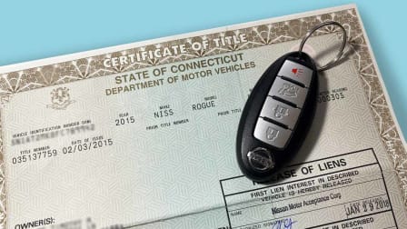 Car key on top of Certificate of Title