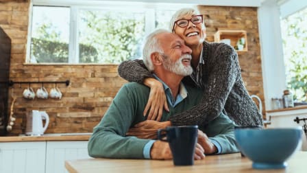 A Happy Elderly couple in their kitchen at home