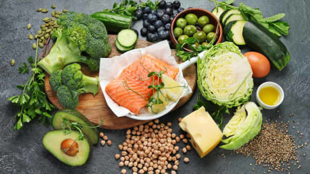 overhead shot of food in a Mediterranean diet (vegetables, fruits, nuts, seeds, legumes, whole grains, salmon, eggs)