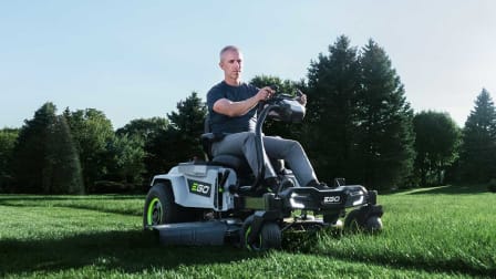 A person riding a Ego ZT4205S on a lawn.