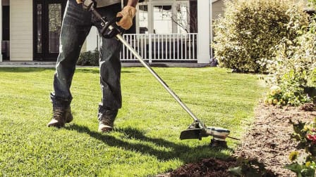 A person using the Makita XRU15PT string trimmer.