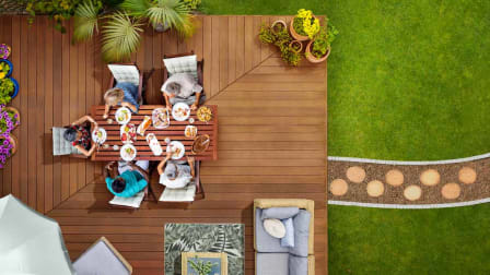Overhead view of deck with people at a table eating outdoors