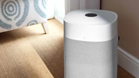 Blueair Blue Pure 211i Max Air Purifier on floor next to chair