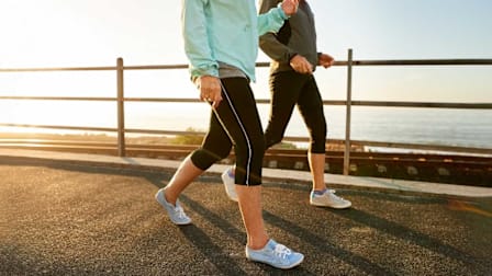 Two women walking outside near the ocean