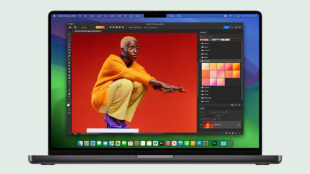 Apple Mac laptop with Adobe Photoshop 2023 on screen with person in yellow outfit squatting with arms extended