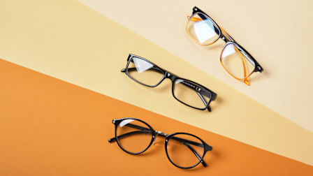 3 eyeglasses, each on a shade of orange background