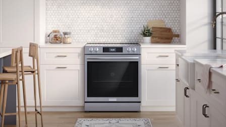 Frigidaire Gallery GCFE3060BF Range in kitchen with white cabinets and farmhouse sink