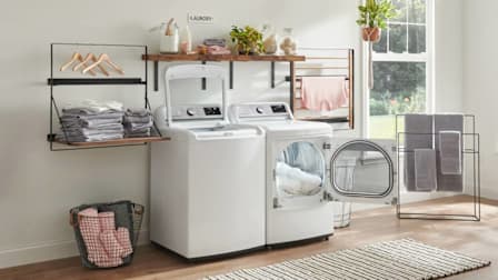 LG WT7800CW washer and LG DLGX7801WE dryer in laundry room with each of their doors open