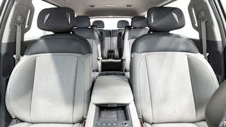 interior of 2024 Kia EV9 showing three rows of seating with grey fabric