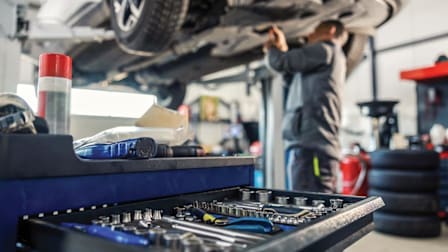 A mechanic working on a car in a shop