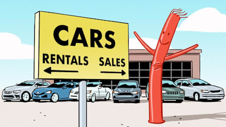 Sign pointing to rental and sales cars with a tube man floating near.