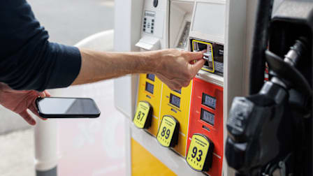 Close-up of person paying for gas at pump