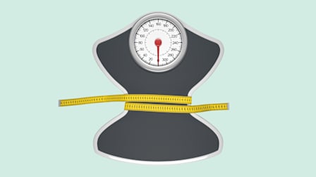 scale with measuring tape cinching the middle
