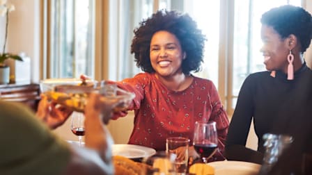family and friends gathered at a dining table sharing a meal