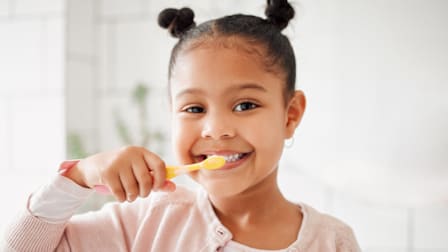A young girl brushing her teeth