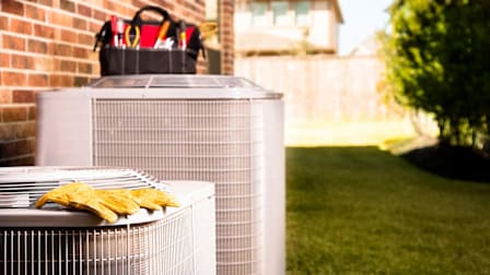 Work tools on air conditioners. Outside residential home.