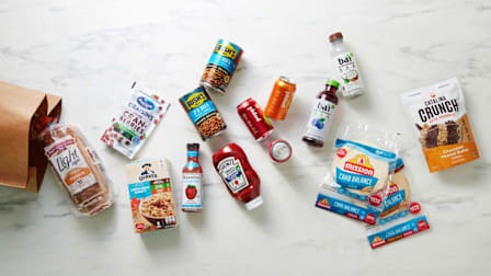 paper grocery bag with various low and no sugar grocery items coming out of it