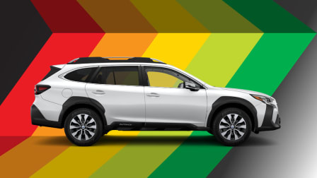White Subaru Outback on blocks of colors: red, orange, yellow, lime, and green.